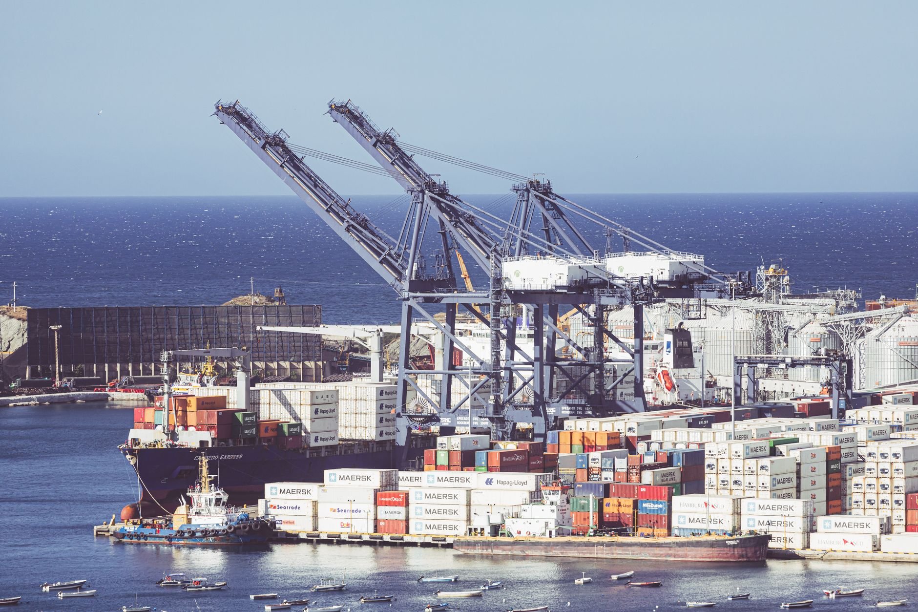 Container shipping port with cranes and cargo vessels representing logistics coordination