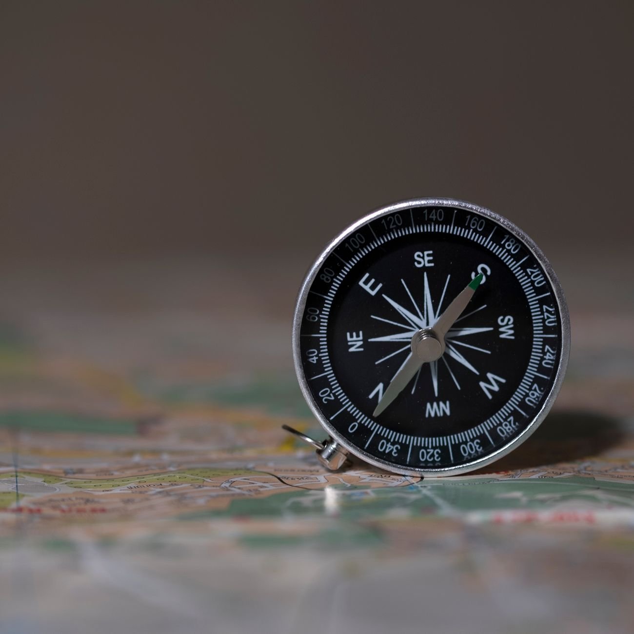 Compass resting on a trade route map, symbolizing navigation and regional expertise